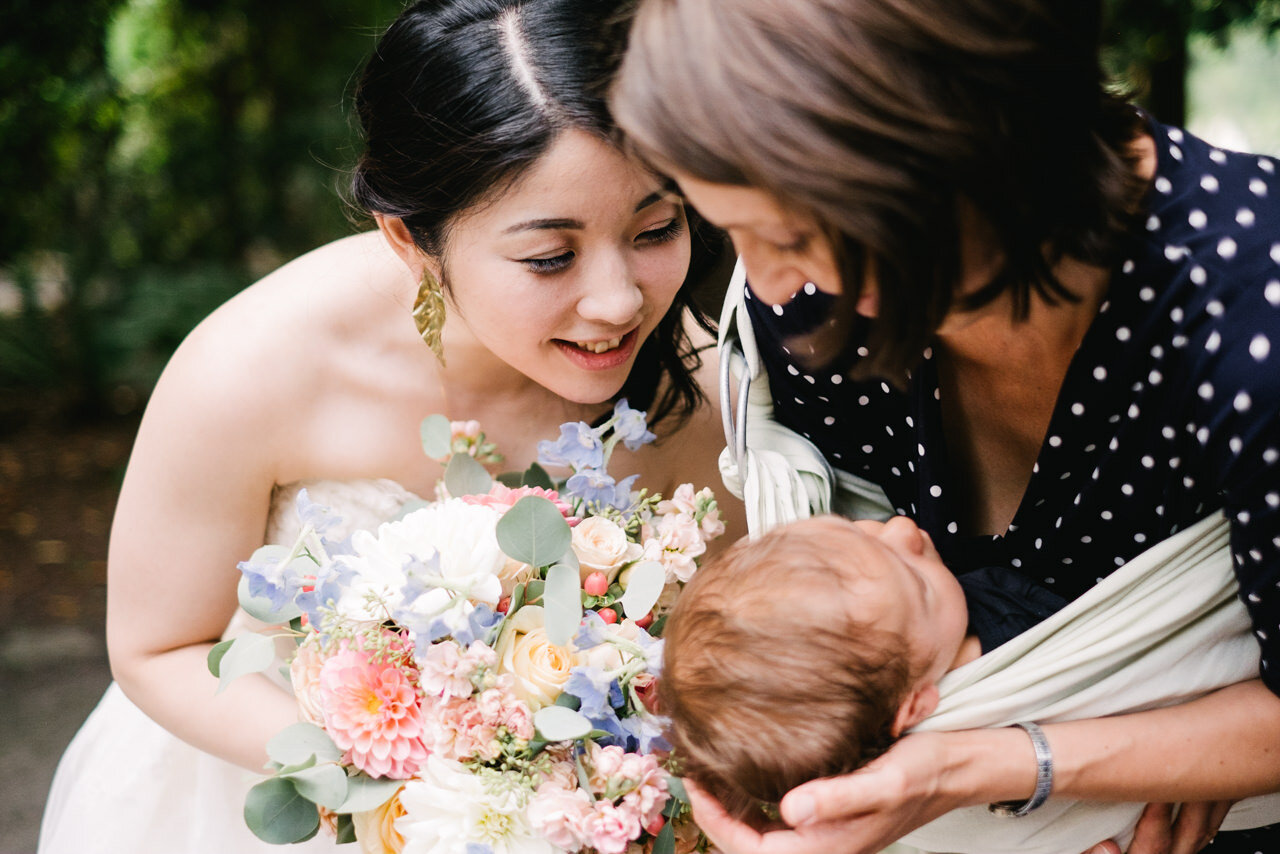  Bride looks closely at baby niece 