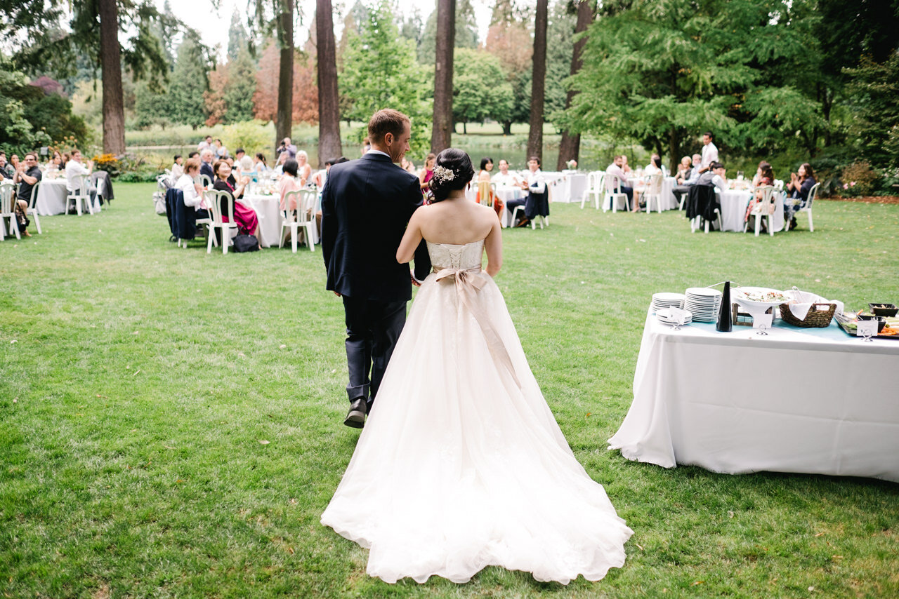  Bride and groom enter wedding reception in open lawn at crystal springs rhododendron garden 