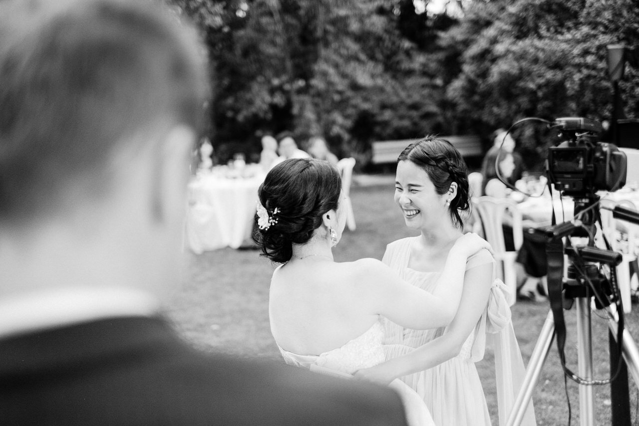  Bridesmaid hugs bride in black and white 