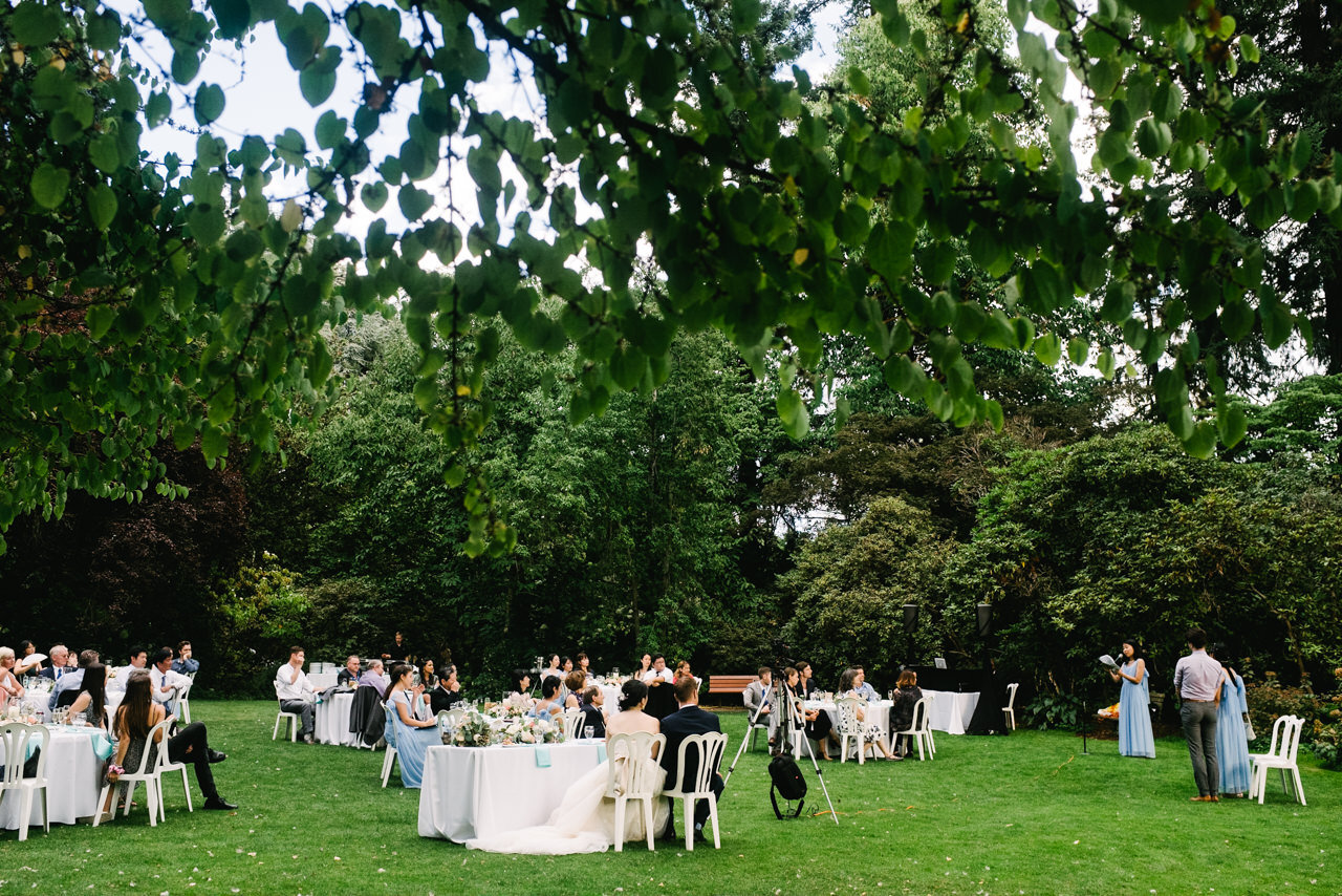  Wedding lawn shows reception tables and bridesmaid giving a toast 