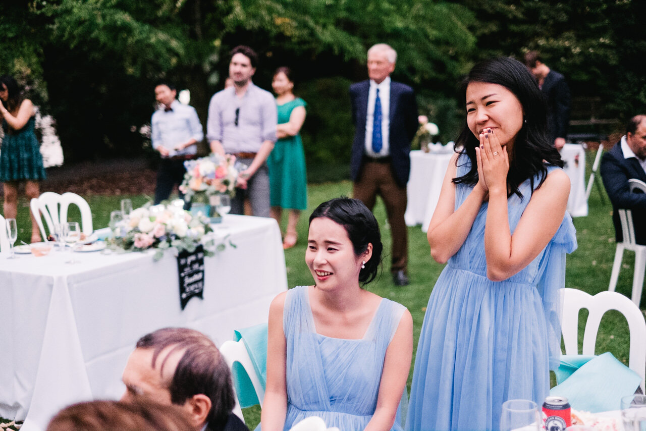  Bridesmaids in blue listen during wedding toasts 