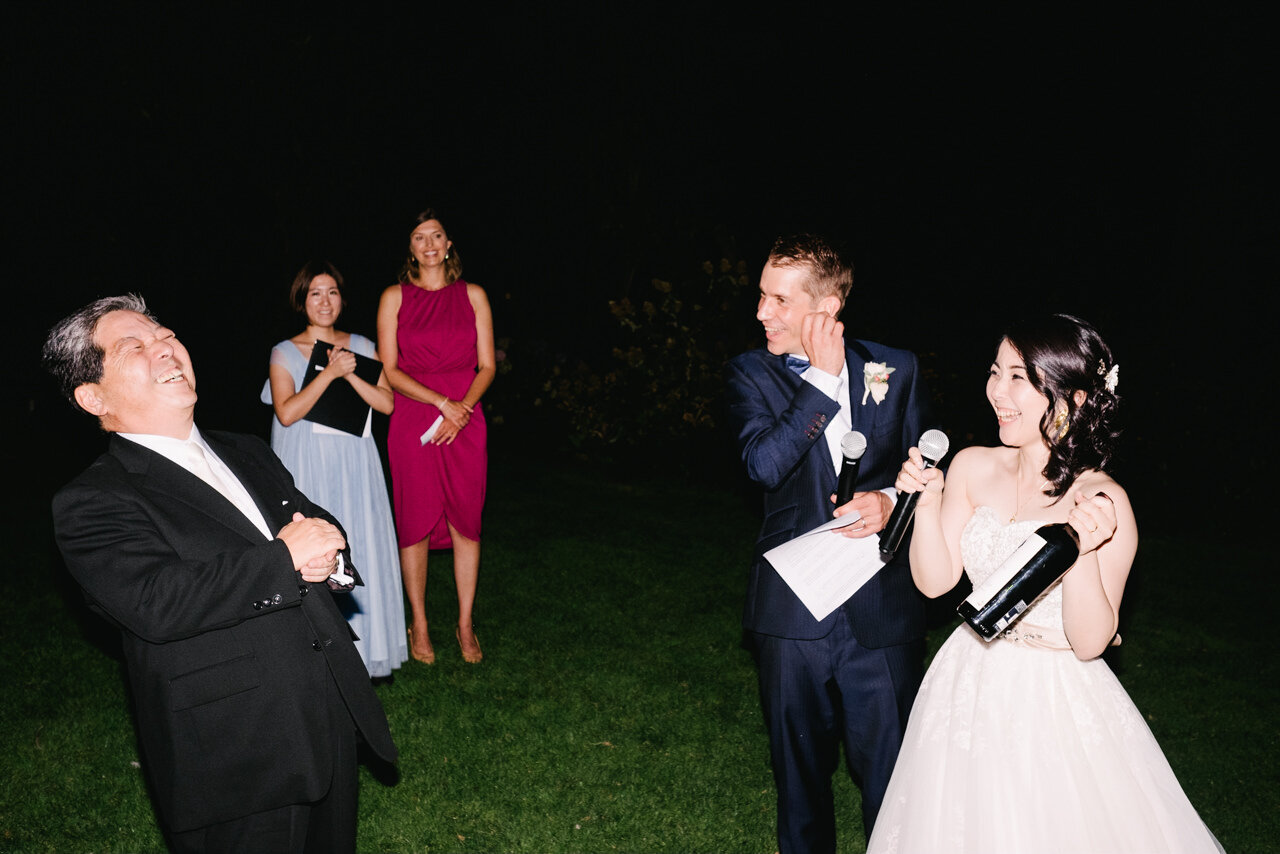  Night toast with father of bride at wedding reception 