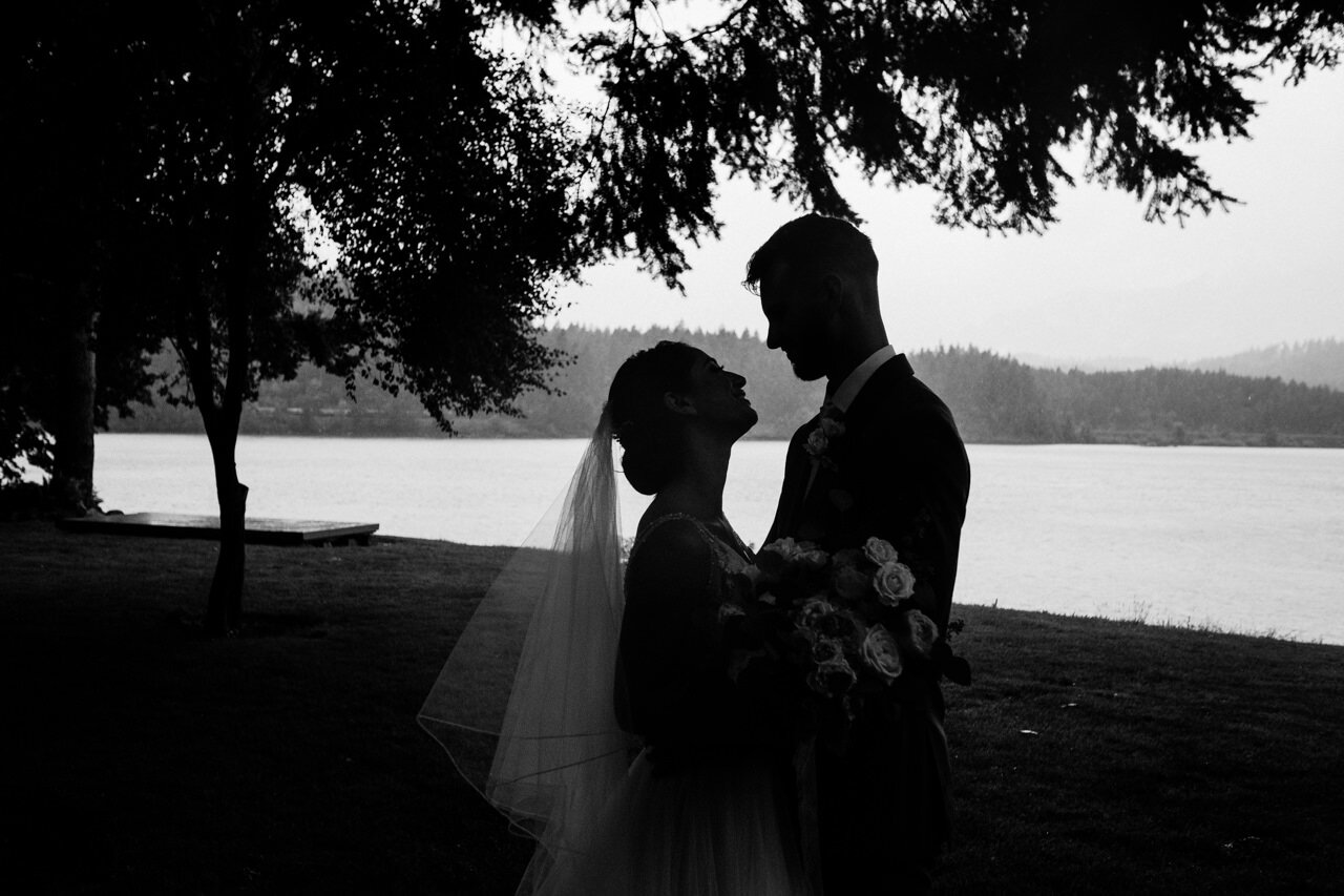  Silhouette of bride and groom by Columbia river in black and white 