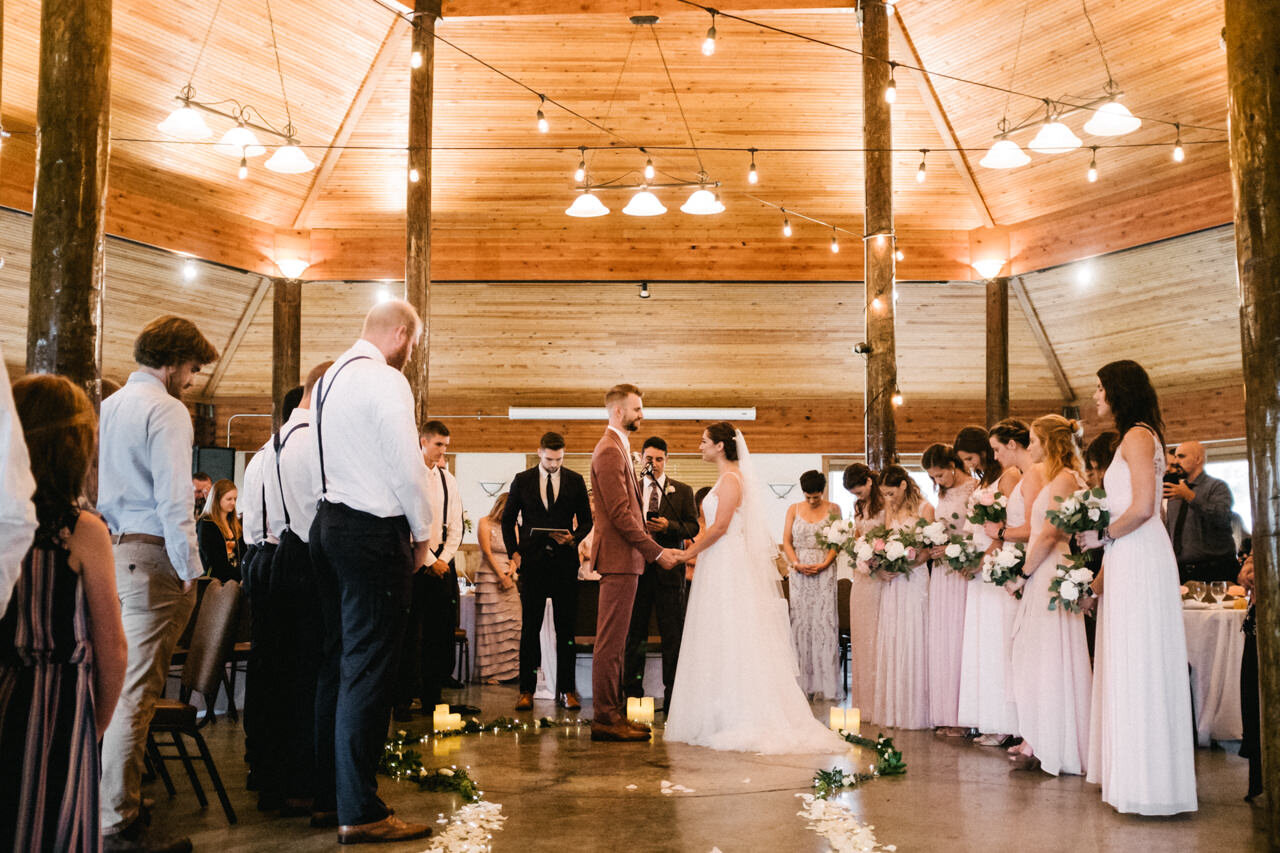  Wooden pavilion wedding at cascade locks with bridesmaids in pink dresses and twinkle lights 