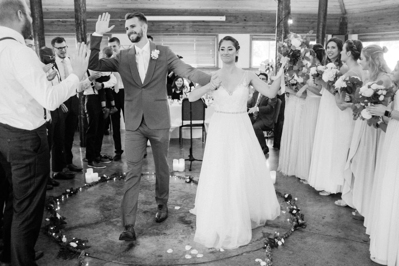  Groom goes for high five as bride dances during recessional 