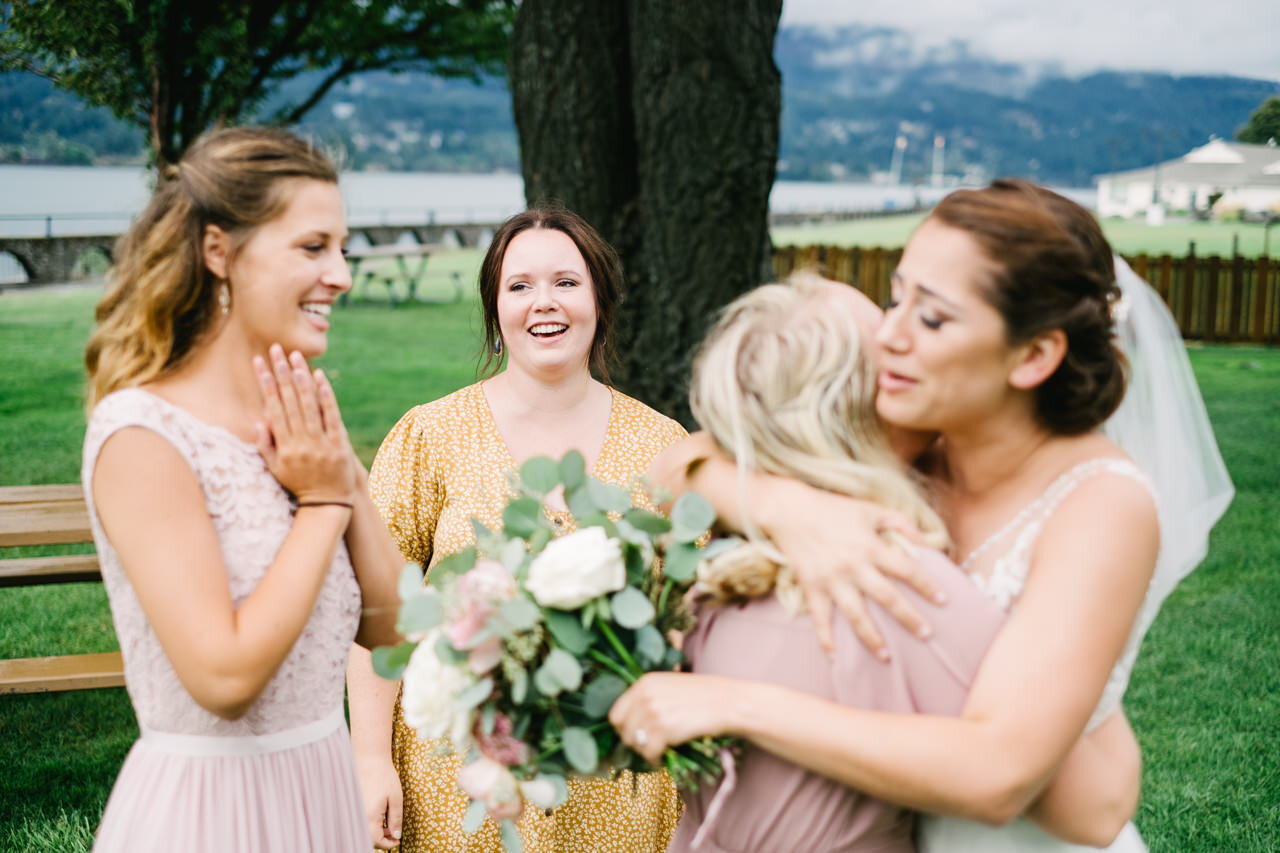  Wedding guests approach bride for hugs in Columbia gorge 