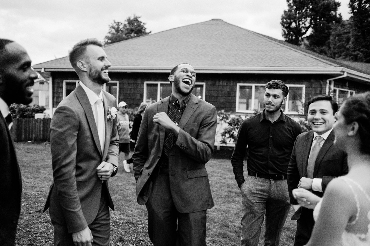  Wedding guests laughing with groom 