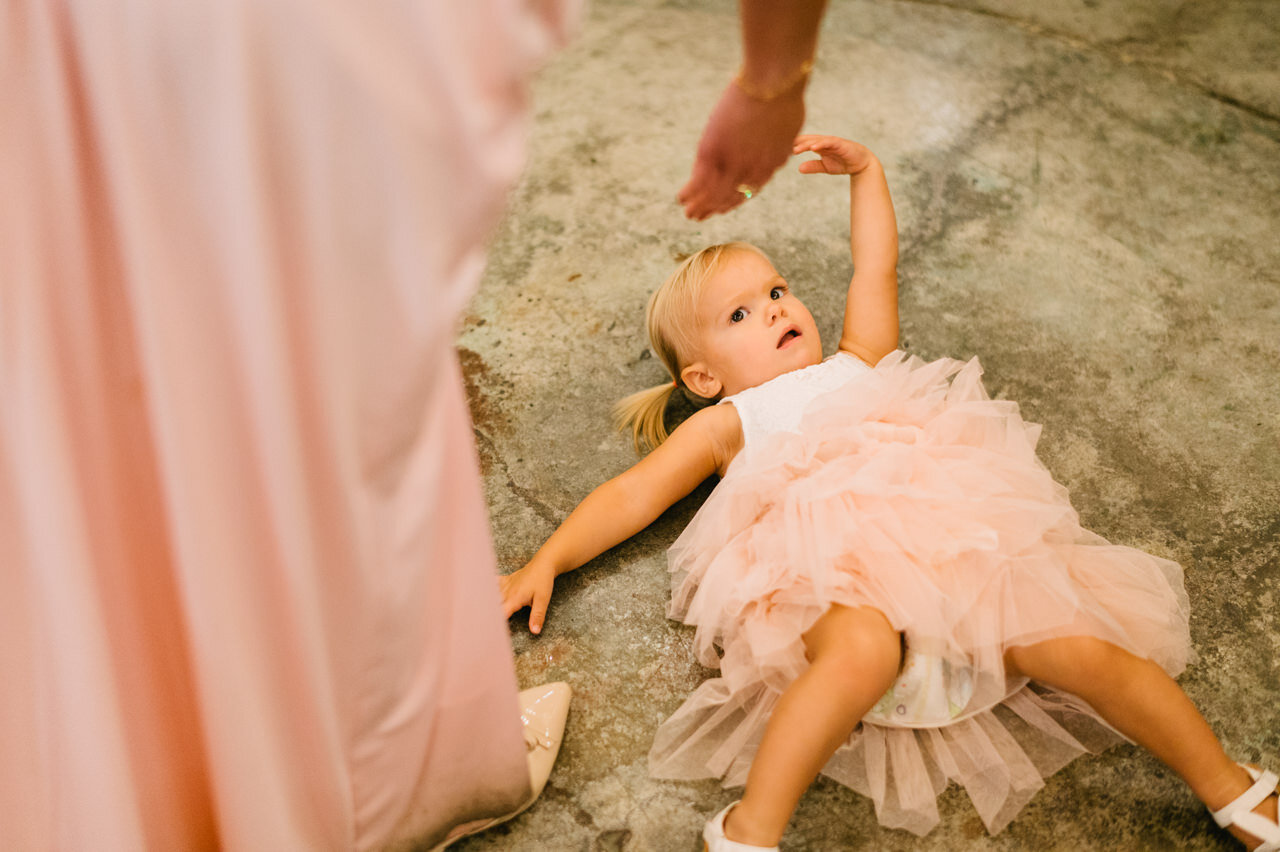  Young wedding girl in pink dress lays on the floor 