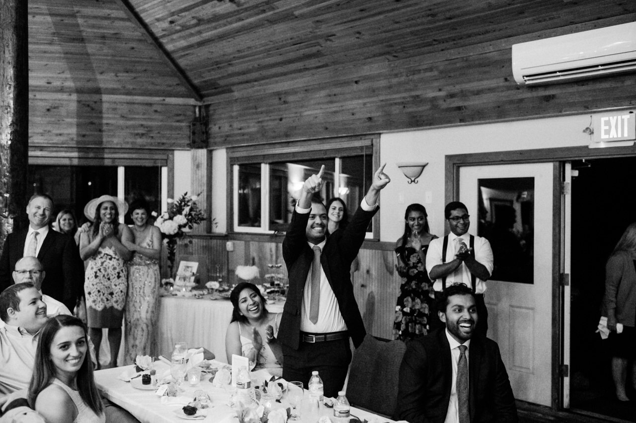  Wedding guest points while everyone laughs 