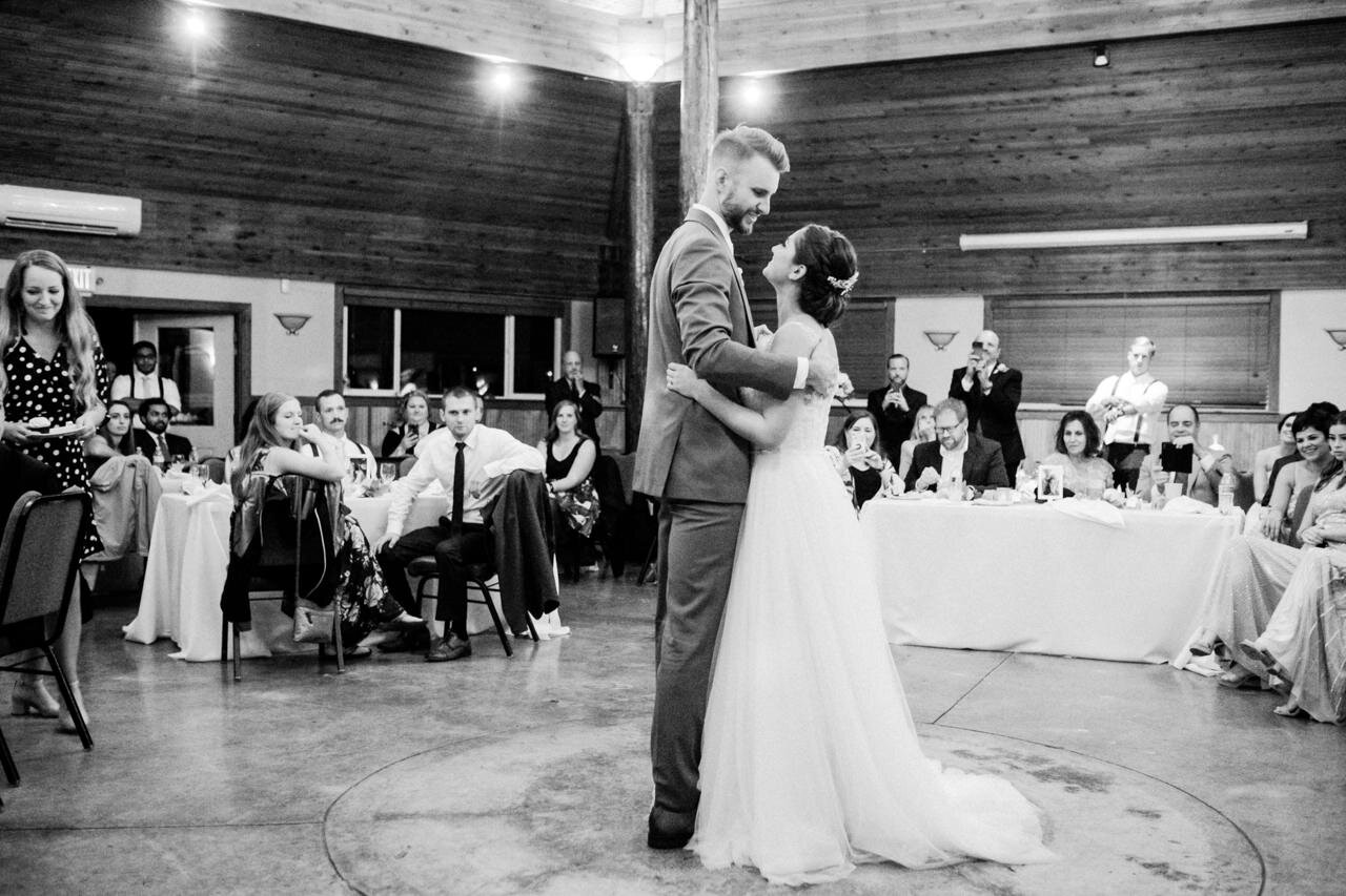  First dance in black and white in wooden wedding pavilion at cascade locks 