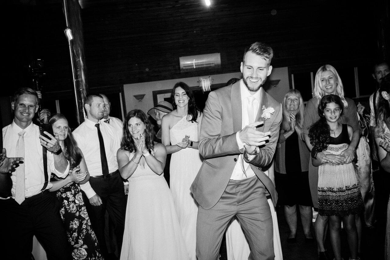  Groom claps during fun wedding dancing 