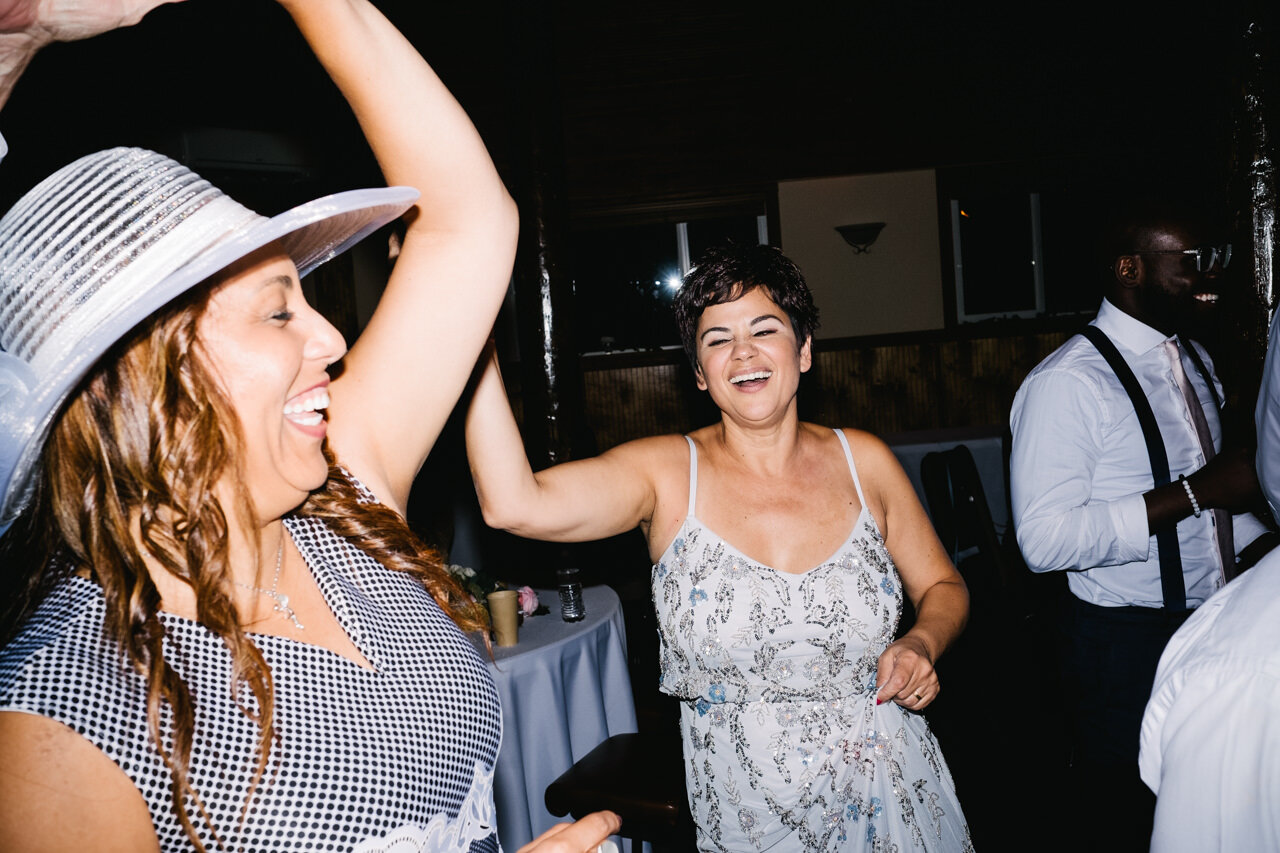  Wedding guests singing with bride on dance floor 