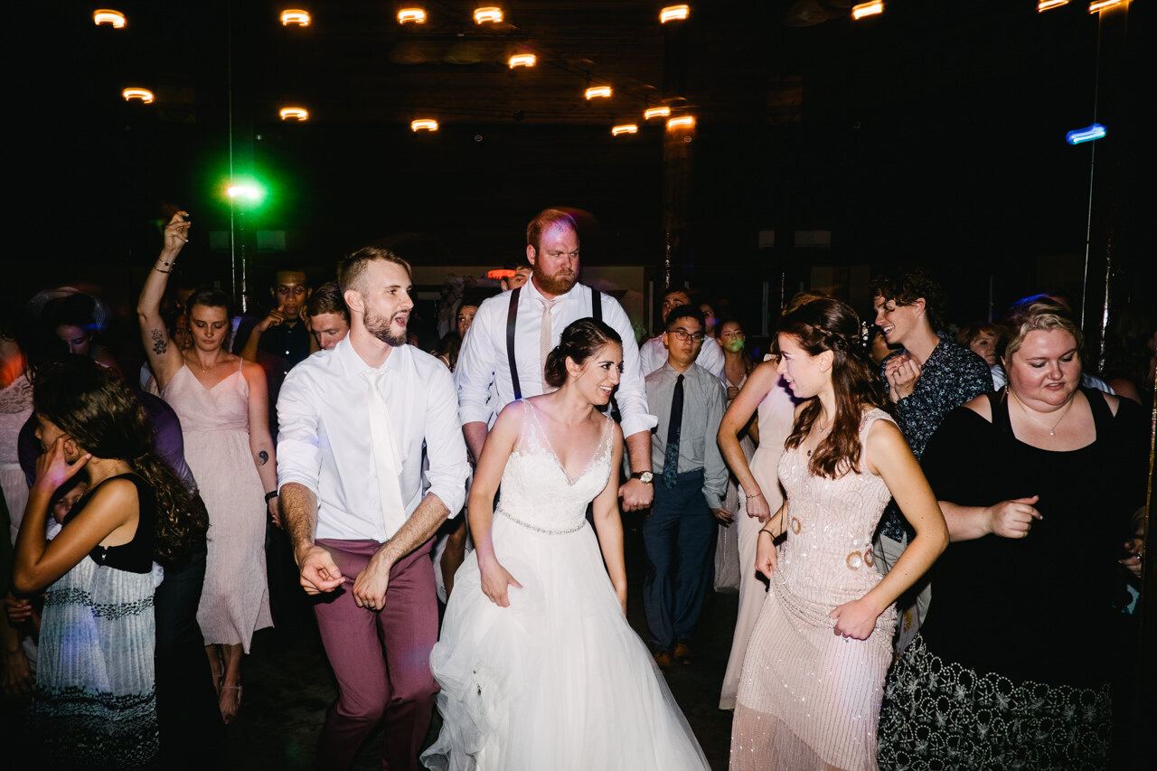  Bride and groom line dance with guests 