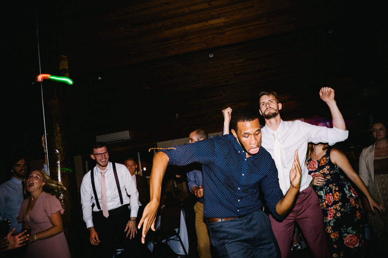  Groom and wedding guest in blue shirt get down dancing 