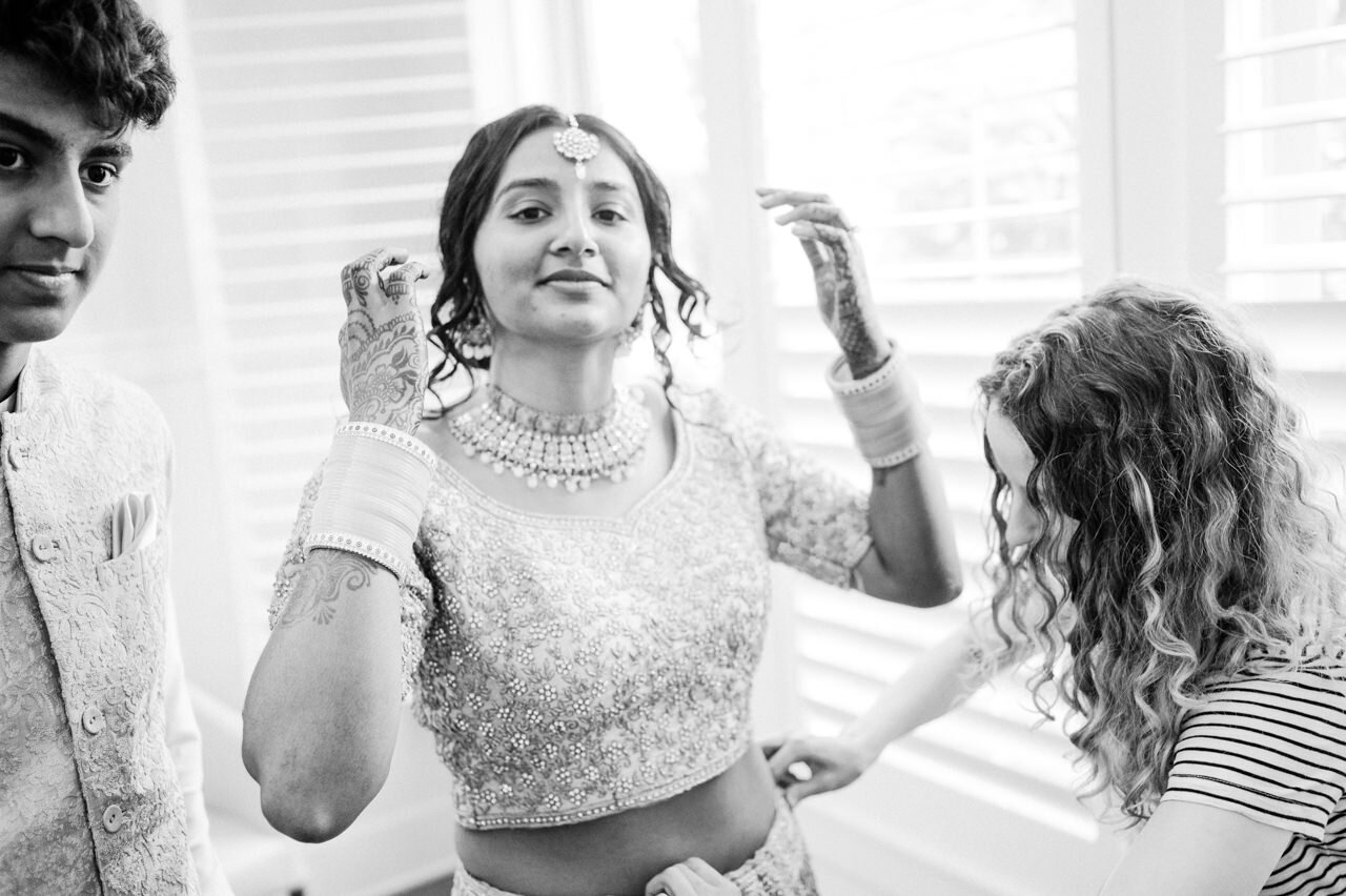  Bride and her brother getting adjusted in mirror 