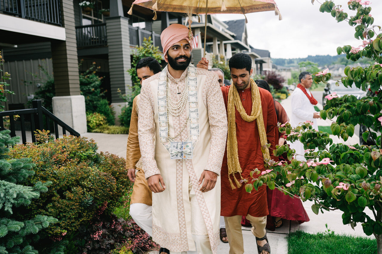  Indian groom arrives smiling with cream outfit 