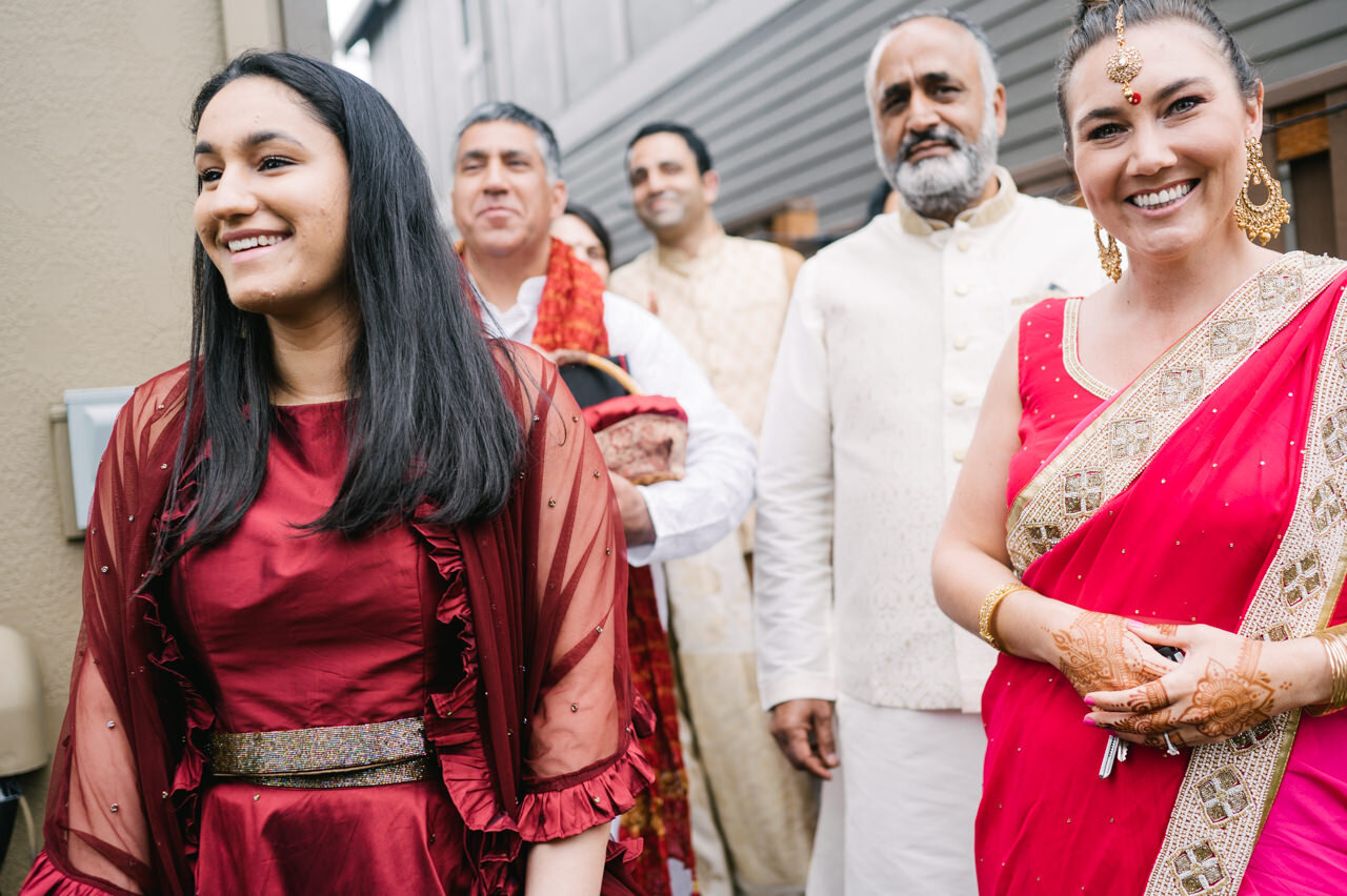  Indian wedding family arriving at wedding with pink and gold sari 