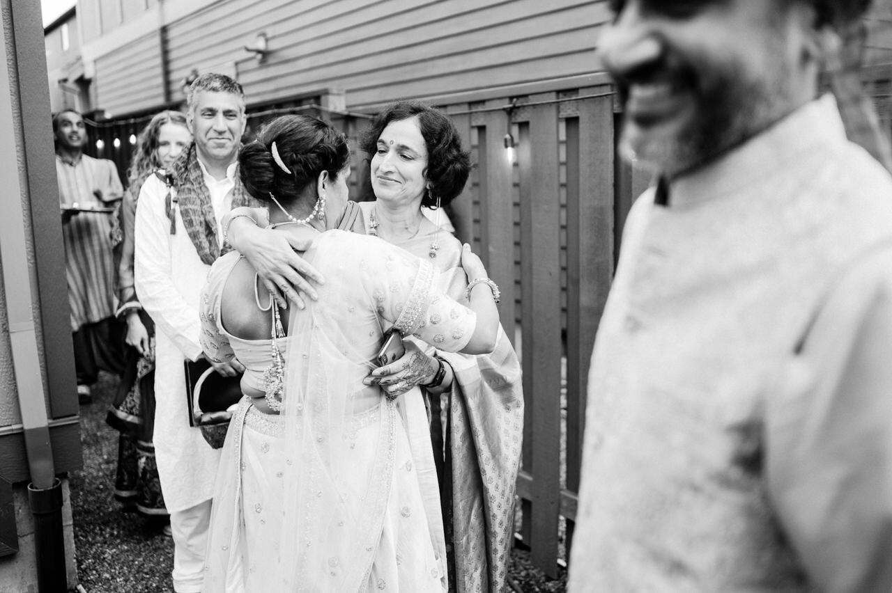  Indian women share hug at arrival to wedding 