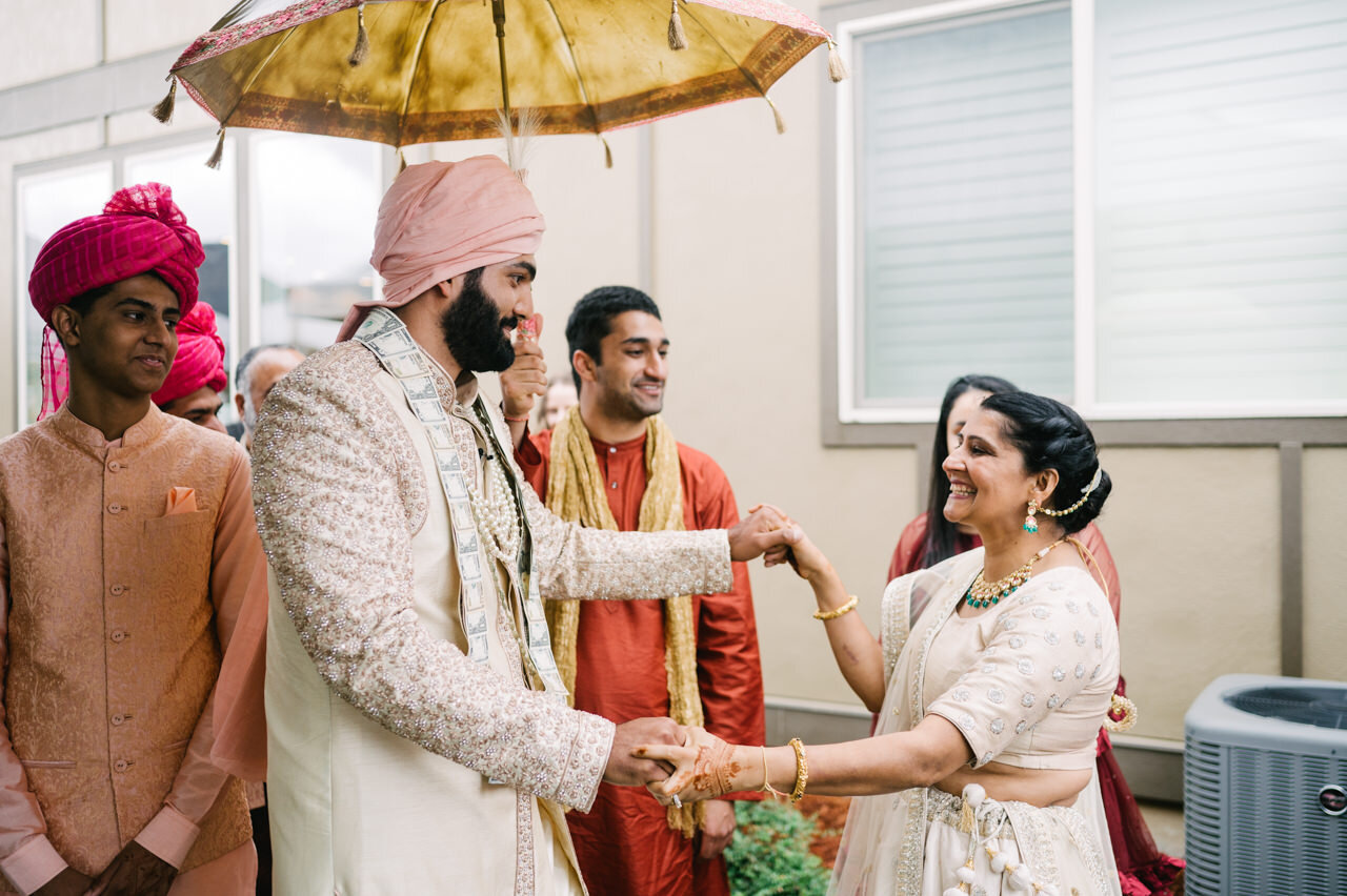  Bride's mother dances with groom in backyard 