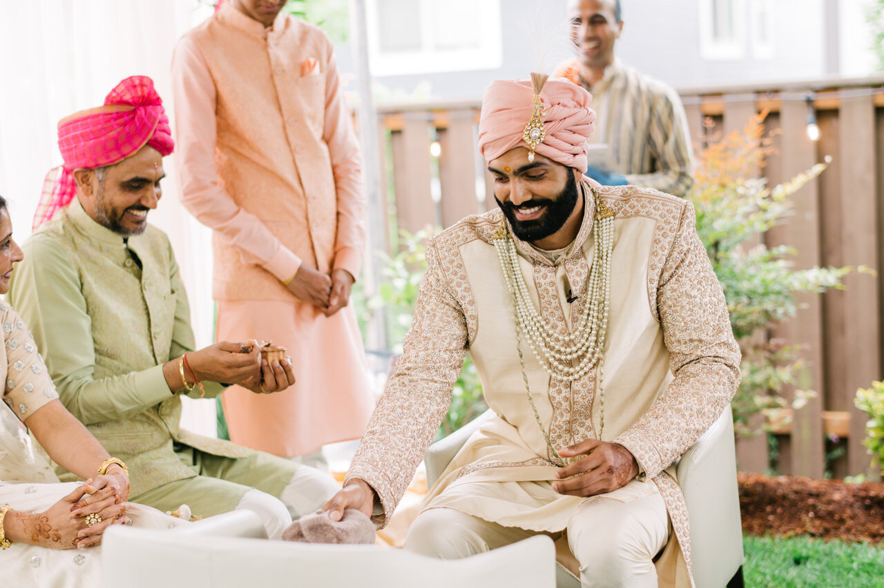  Groom and father share laugh during wedding ceremony 