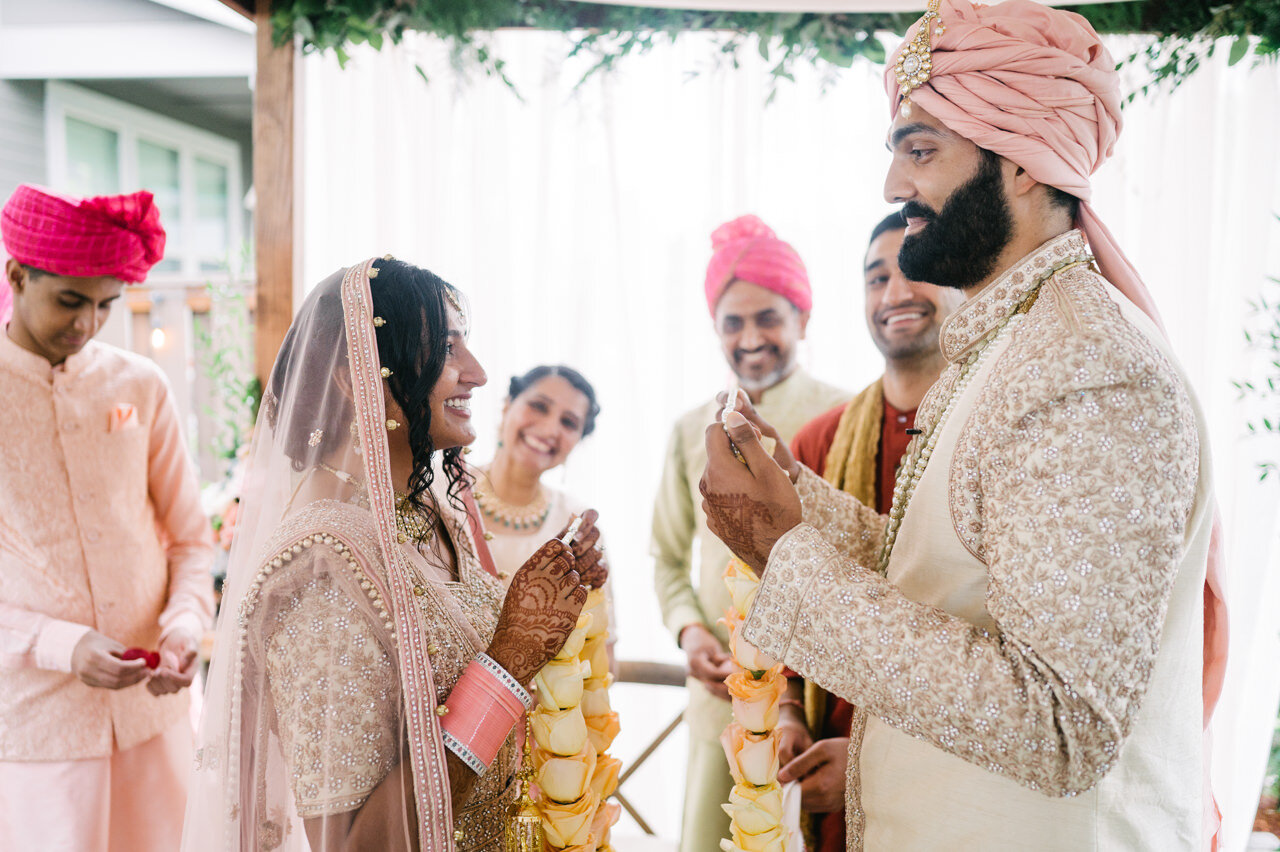  After blanket removed Indian bride and groom share garlands 