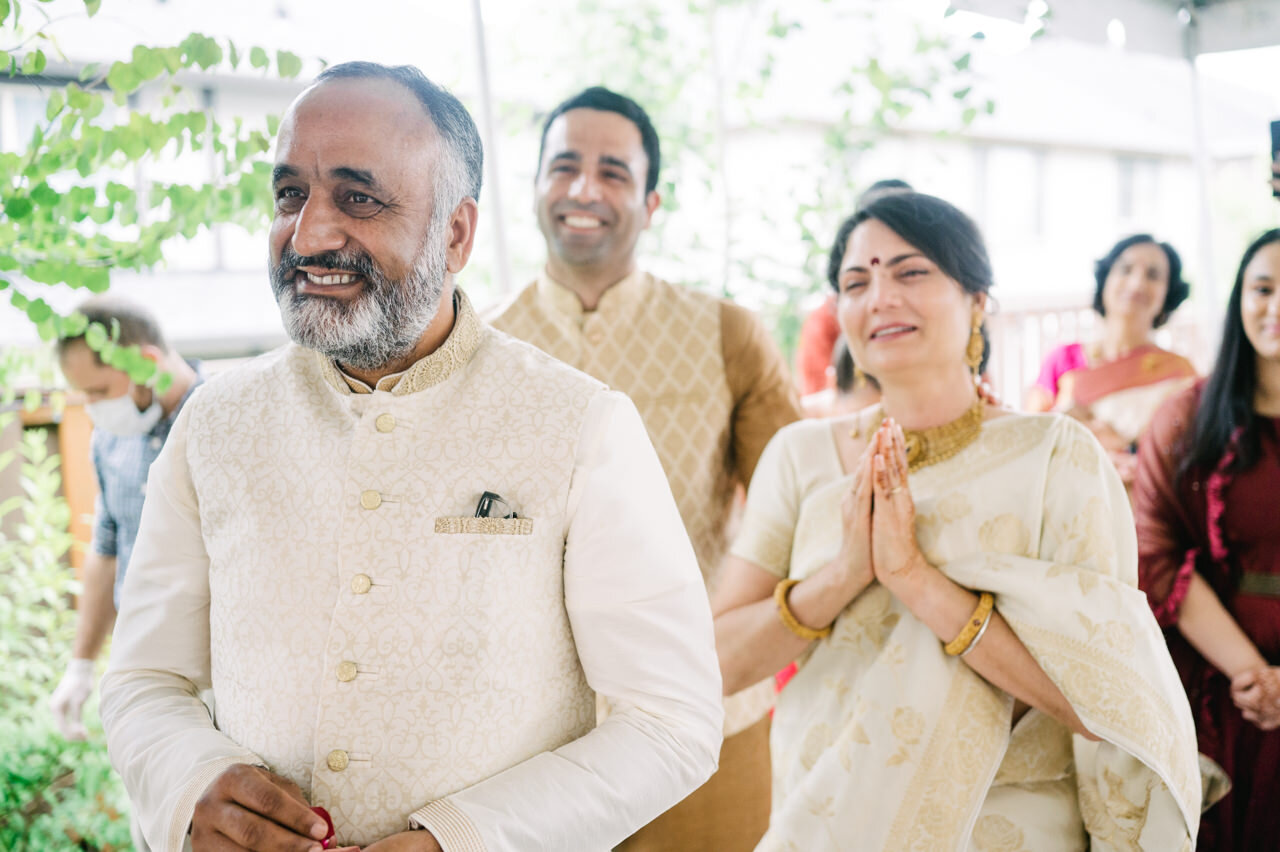  Grooms parents laughing as Indian wedding ceremony begins 