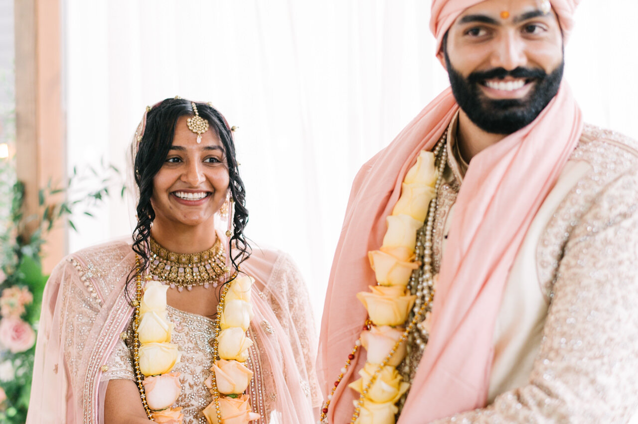  Smiling bride and groom tied by rose and pink 