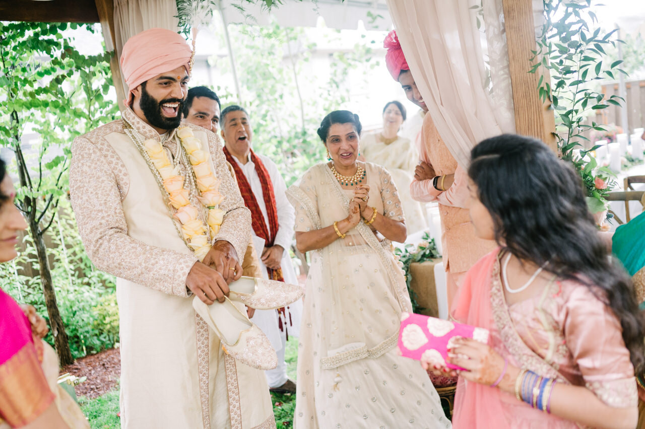  Cousin hides groom shoes while groom laughs 