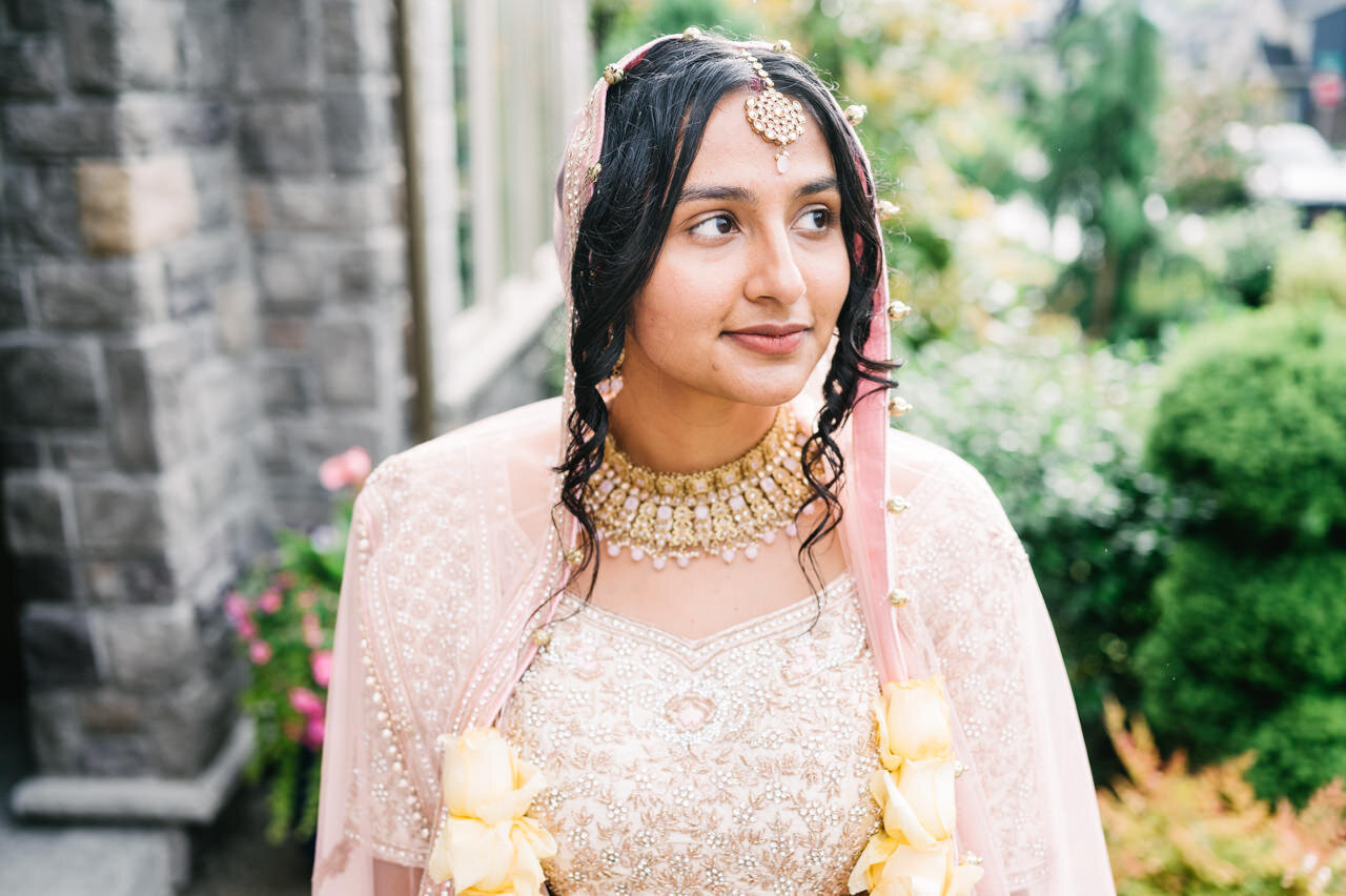  Close up of indian bride with pink shawl and gold sari 