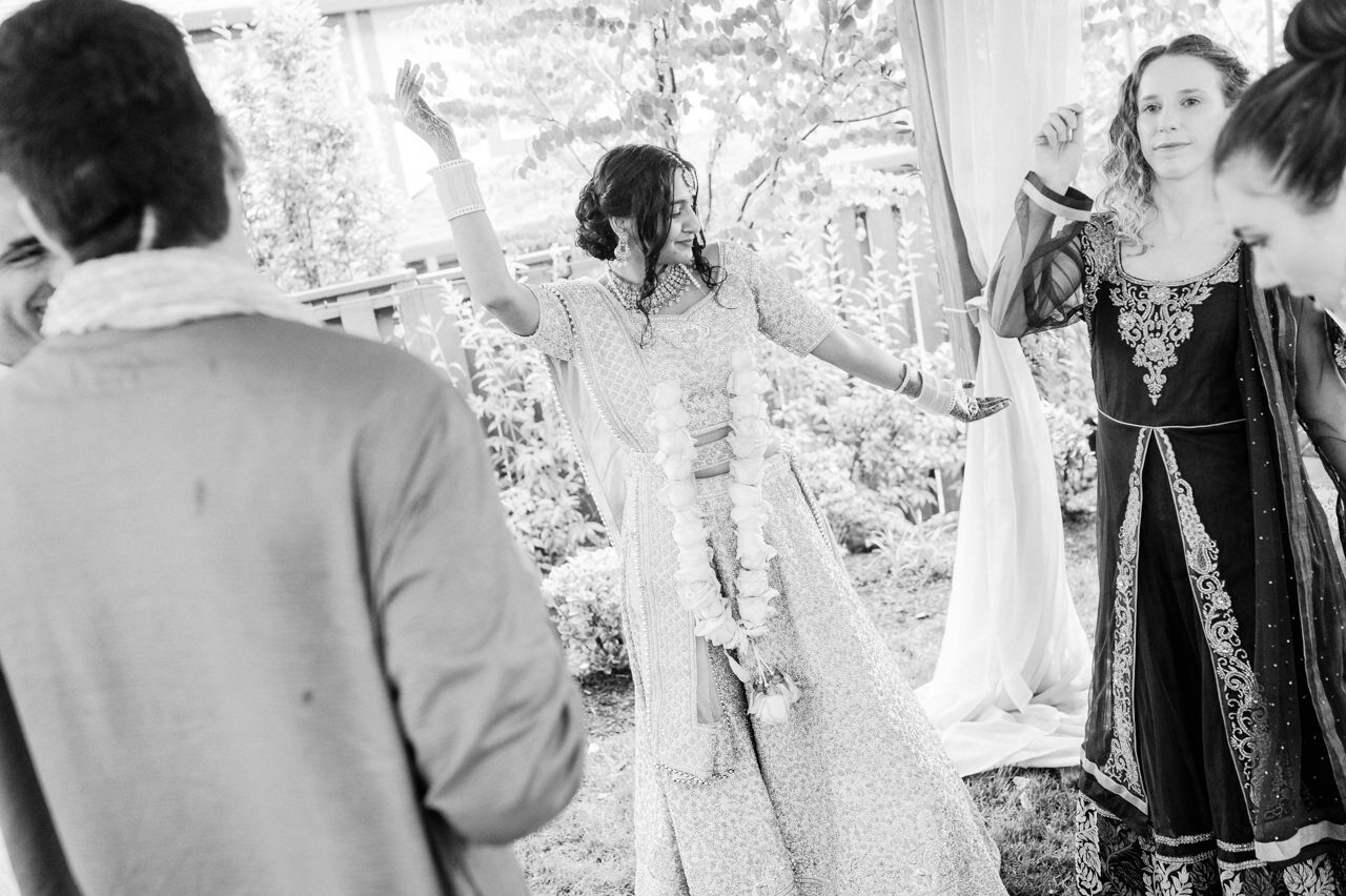  Bride in sari dancing with friends in small backyard wedding 