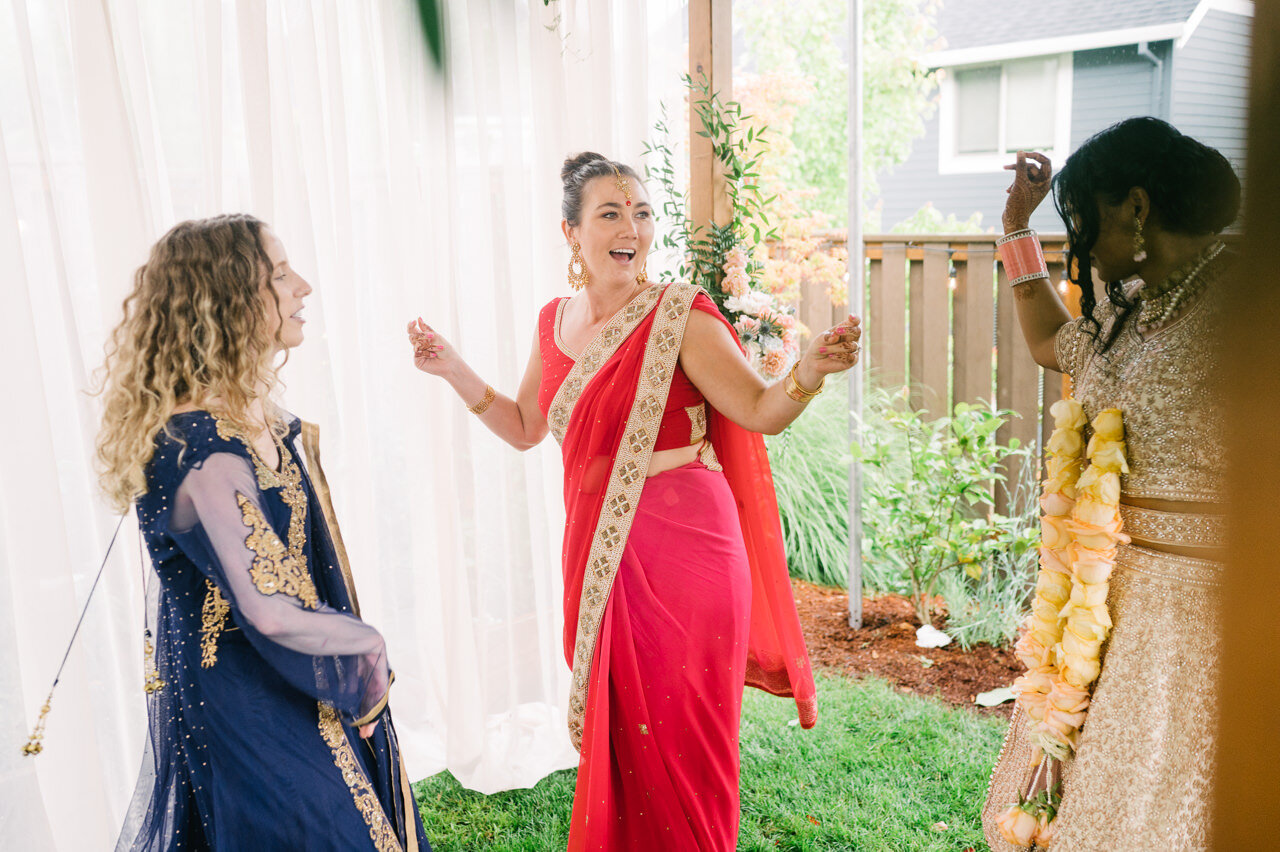  Dancing wedding guest under mandap at indian backyard wedding 
