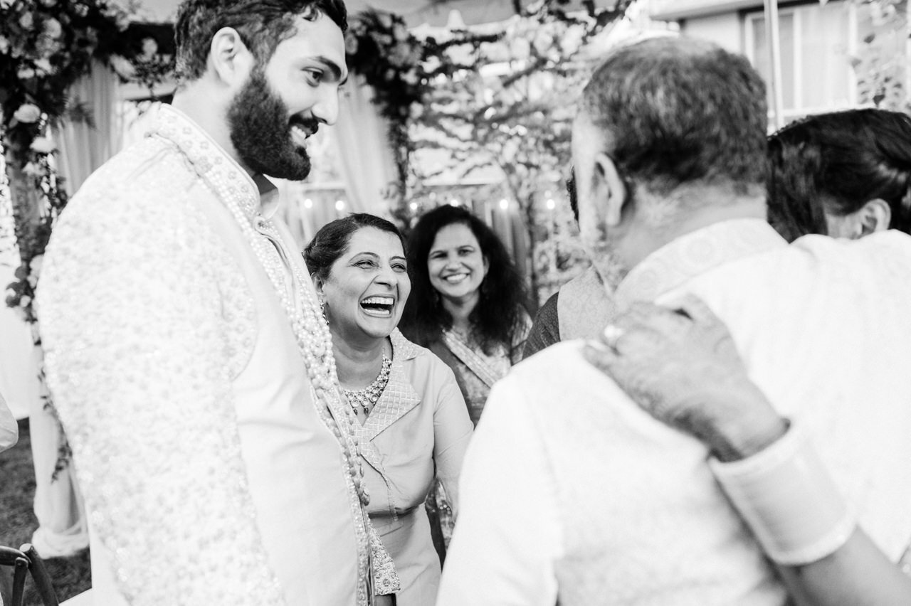  Mother of bride laughs with groom in candid moments 