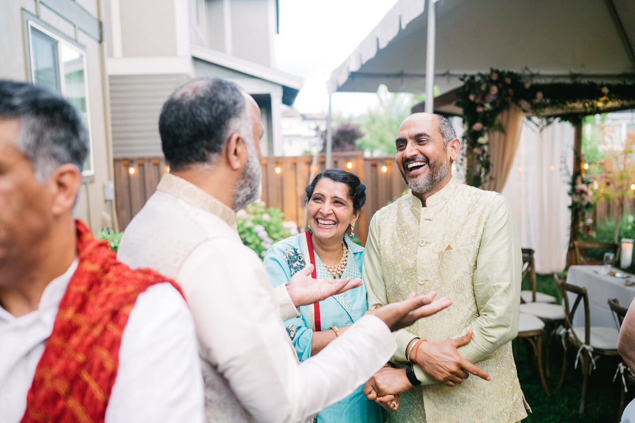  Candid moment of parents laughing in backyard wedding 