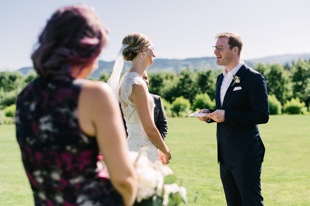  Groom shares vows on lawn at the orchard 