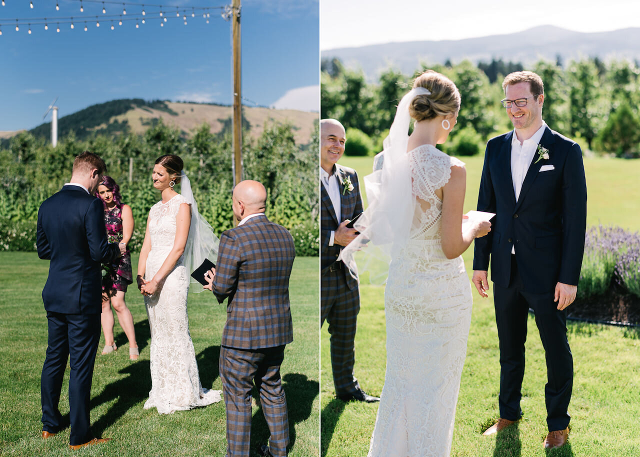  Bride listens to vows standing on lawn in the sun in front of orchards 