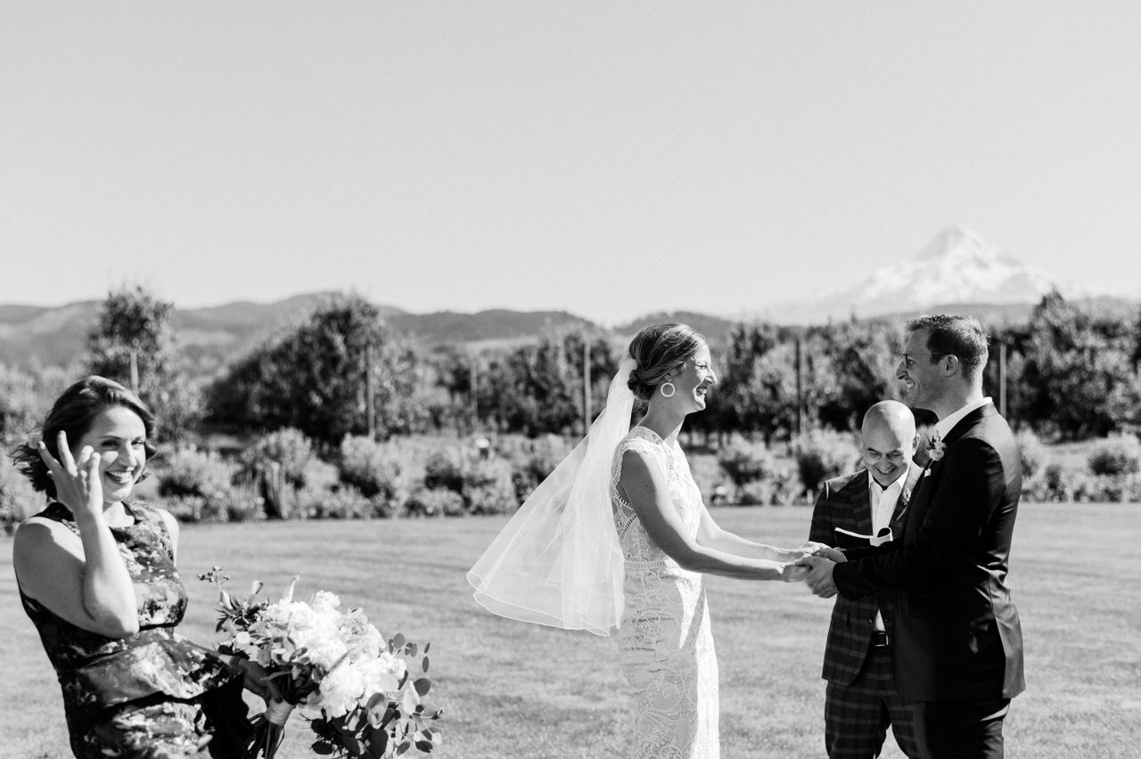  Bride and groom eloping in lawn with maid of honor in front of mt hood 