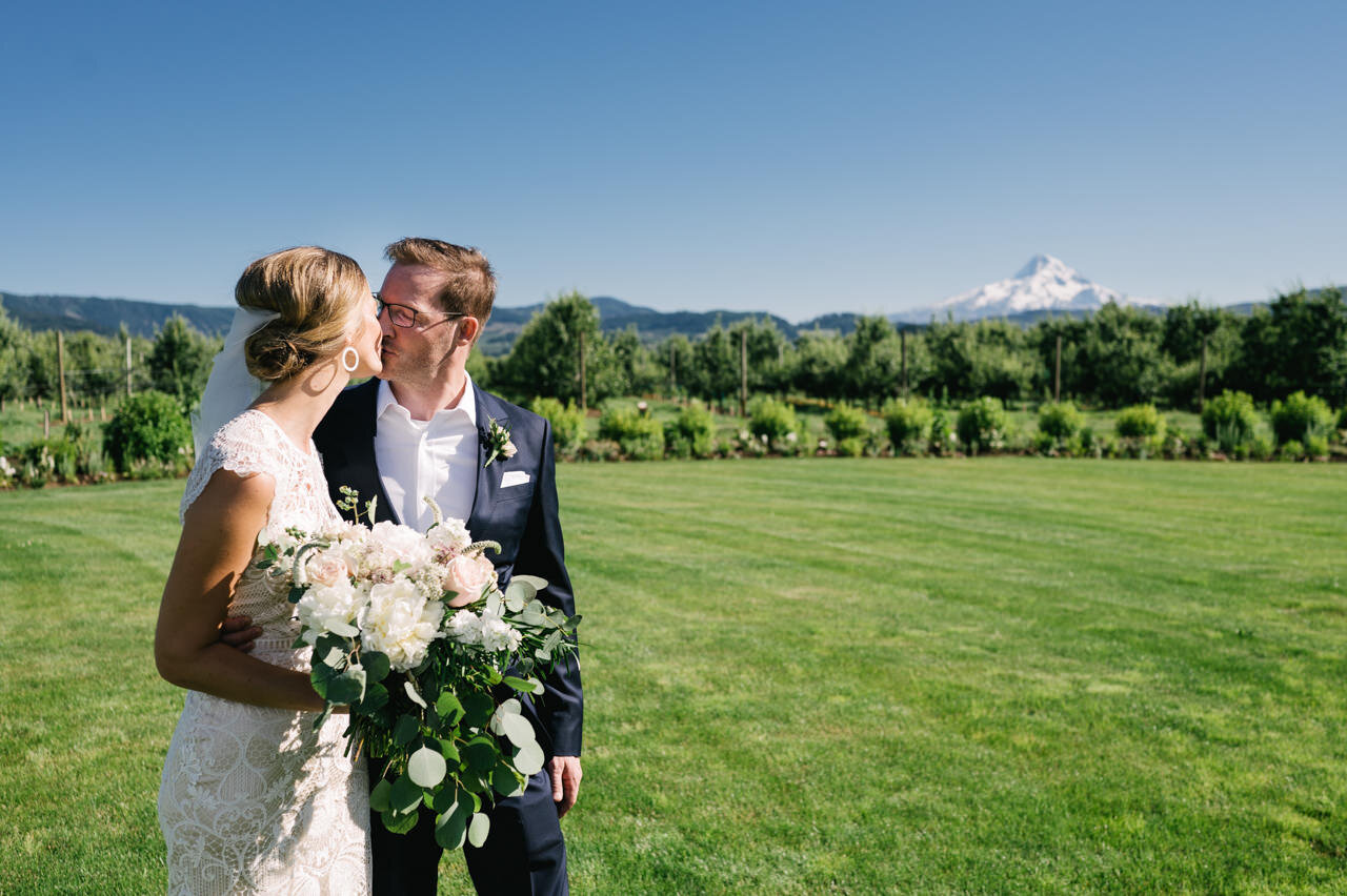  Bride and groom share kiss after elopement in front of mt hood 