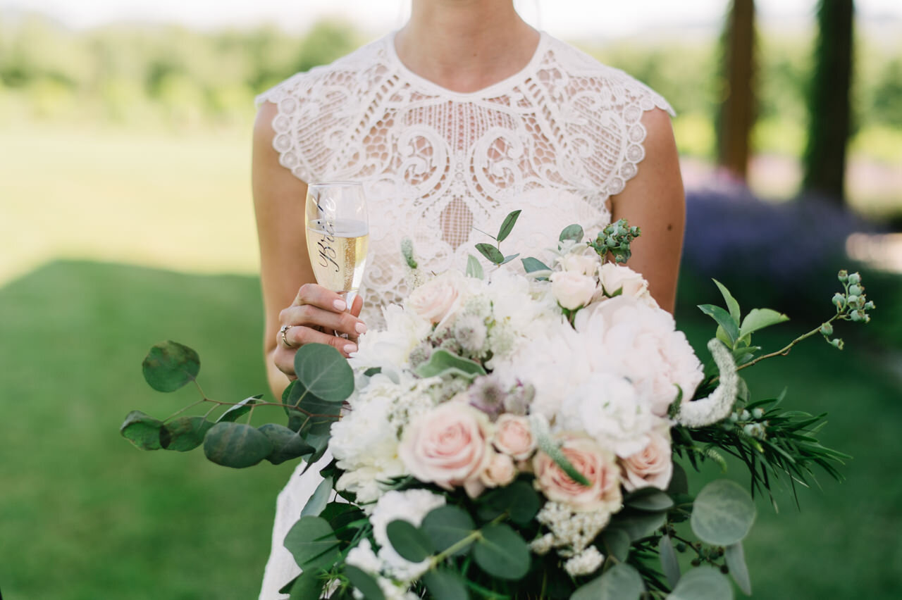  Bride's ornate lace wedding dress and champagne glass 