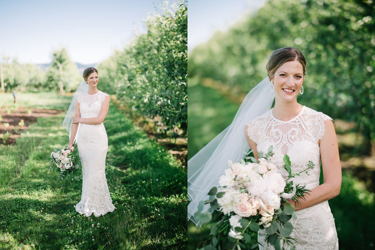  Bridal portrait in lace wedding dress with peach and white bouquet standing in pear orchard 
