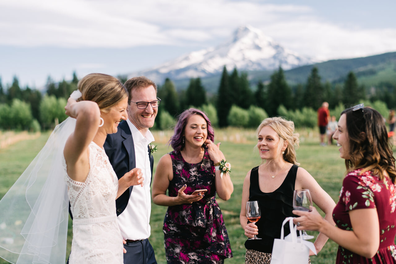  Candid moment at dinner with guests in front of mt hood at grateful vineyards 