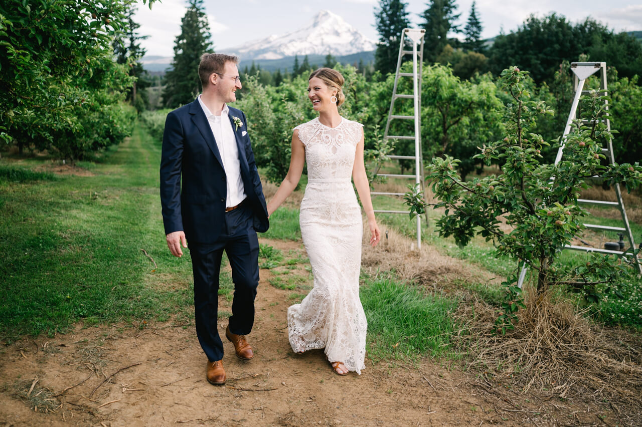  Mt view orchards wedding portraits walking through orchard ladders in front of mt hood 