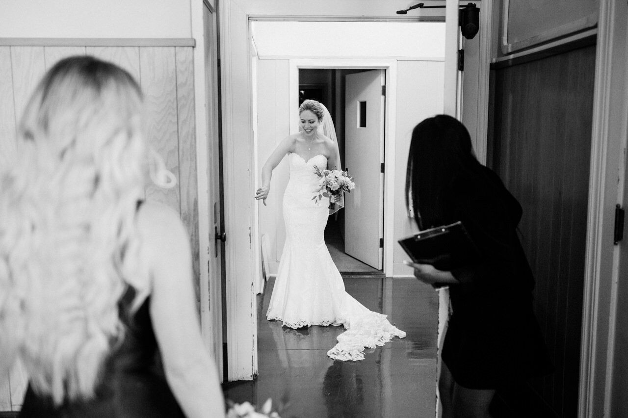  Bride hitting the elevator button as coordinator looks on 