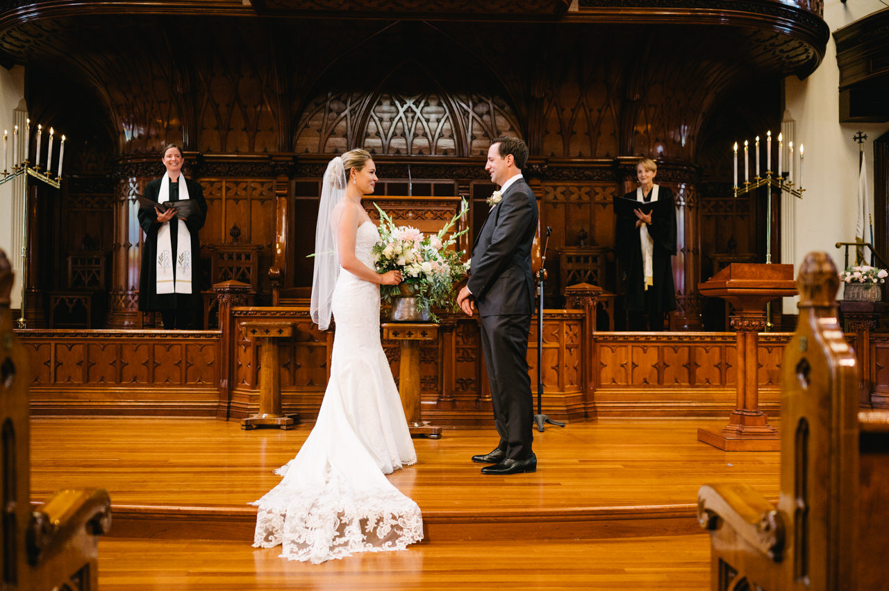  Bride and groom face each other as wedding ceremony begins in cathedral church 