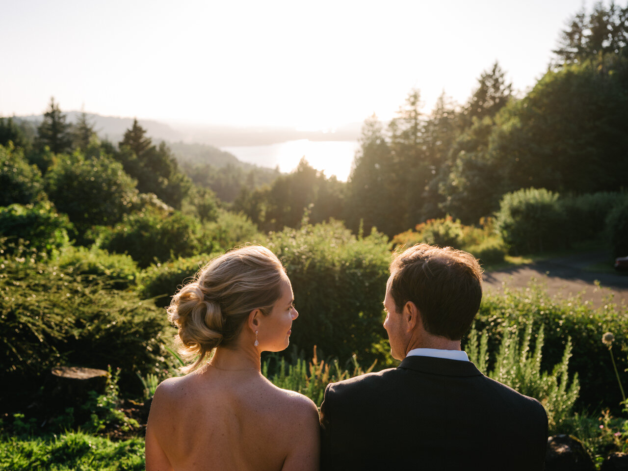  Bride and groom looking at each other as sun gets lower in the sky over Columbia gorge Oregon viewpoint 