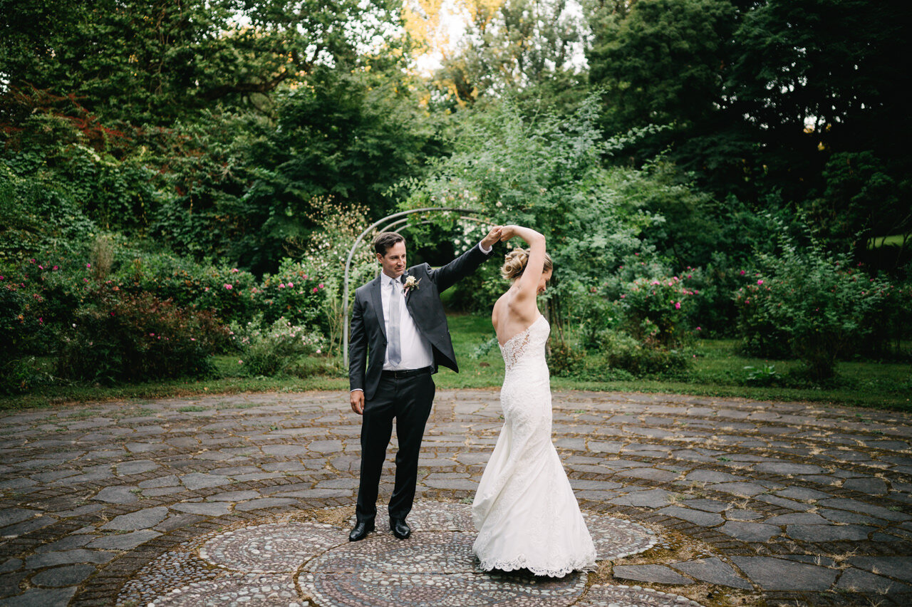  Bride twirls with groom at menucha retreat center labyrinth 