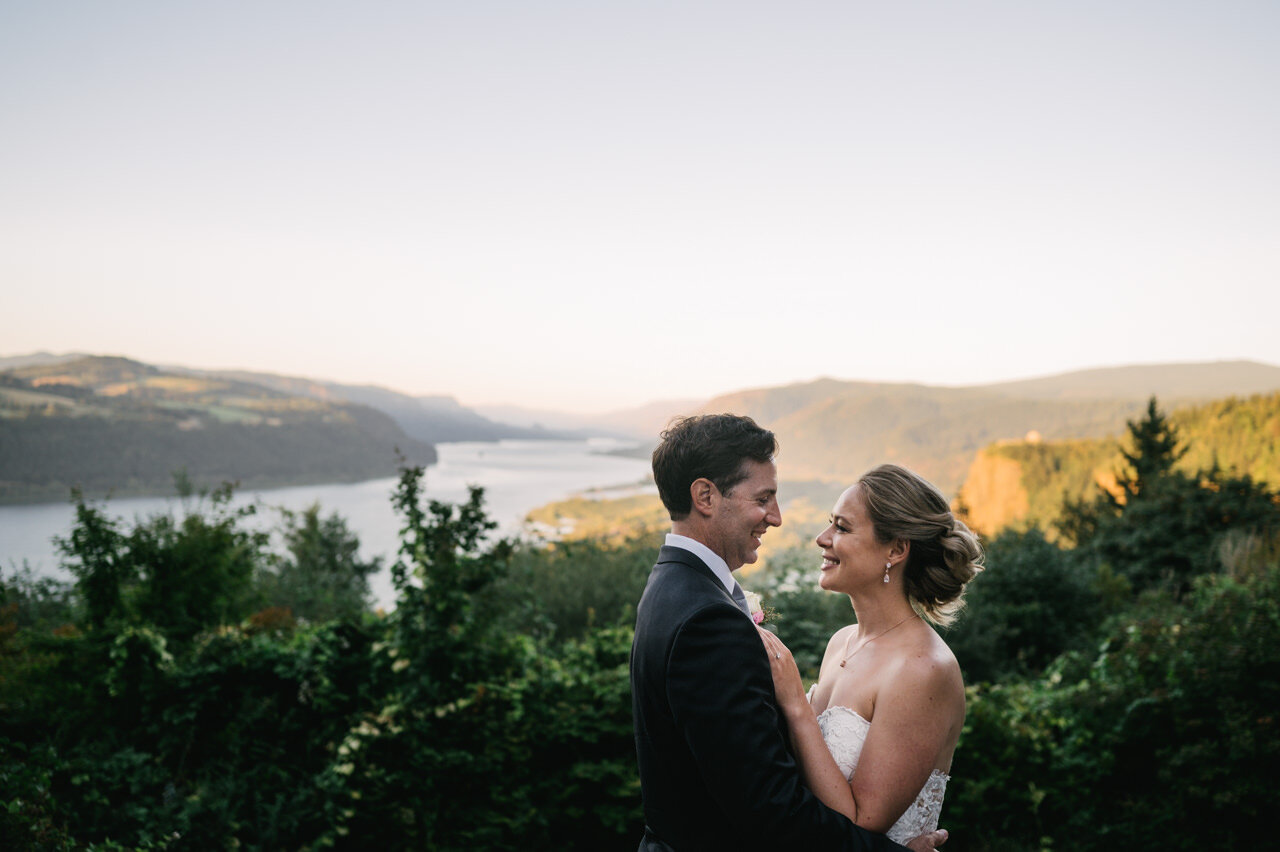  Bride and groom gaze at each other with Columbia gorge in background 