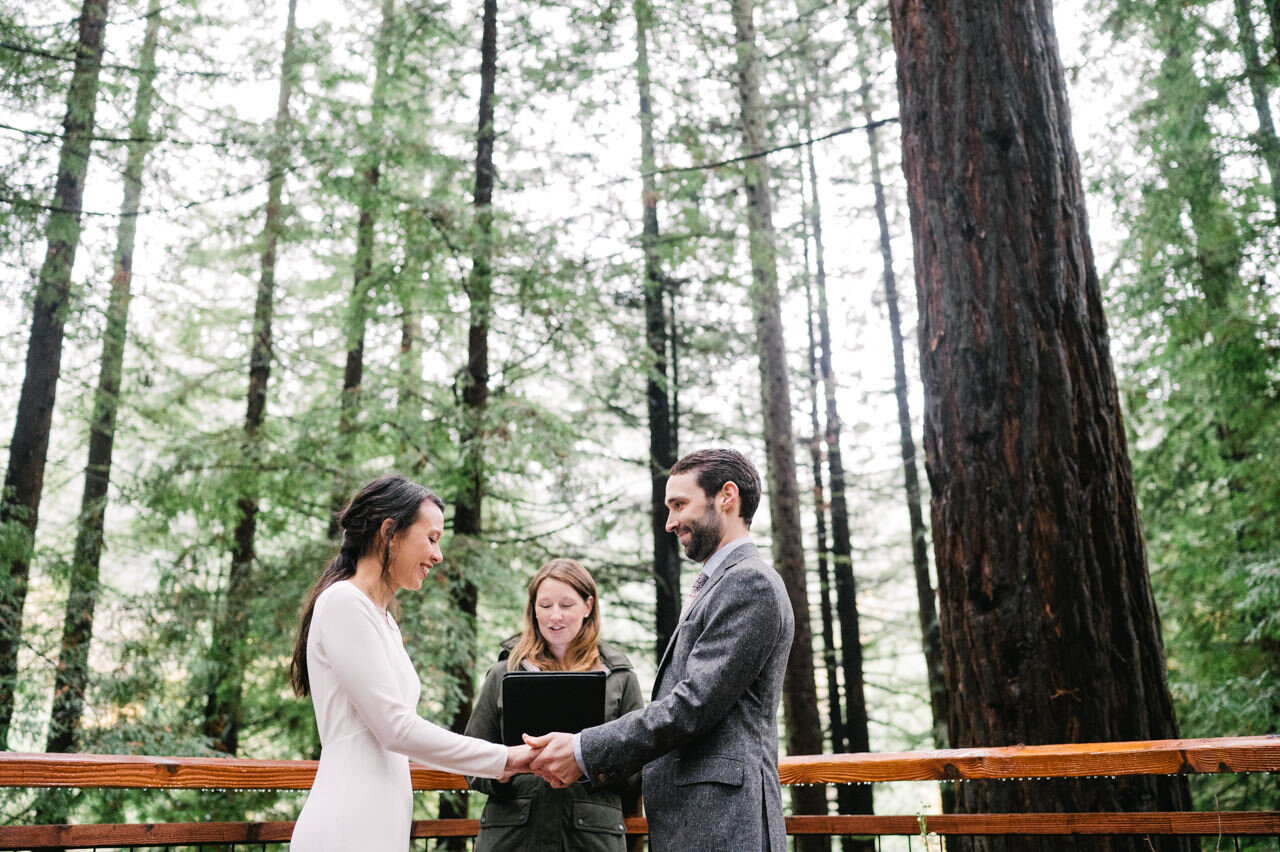  Bride and groom holding hands during wedding elopement sharing vows 