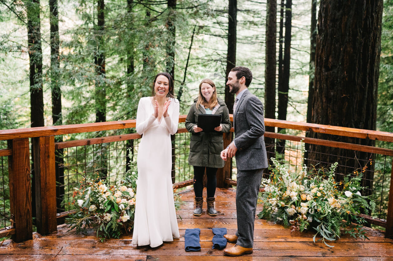  Bride clapping after being announced as just married in redwood forest 