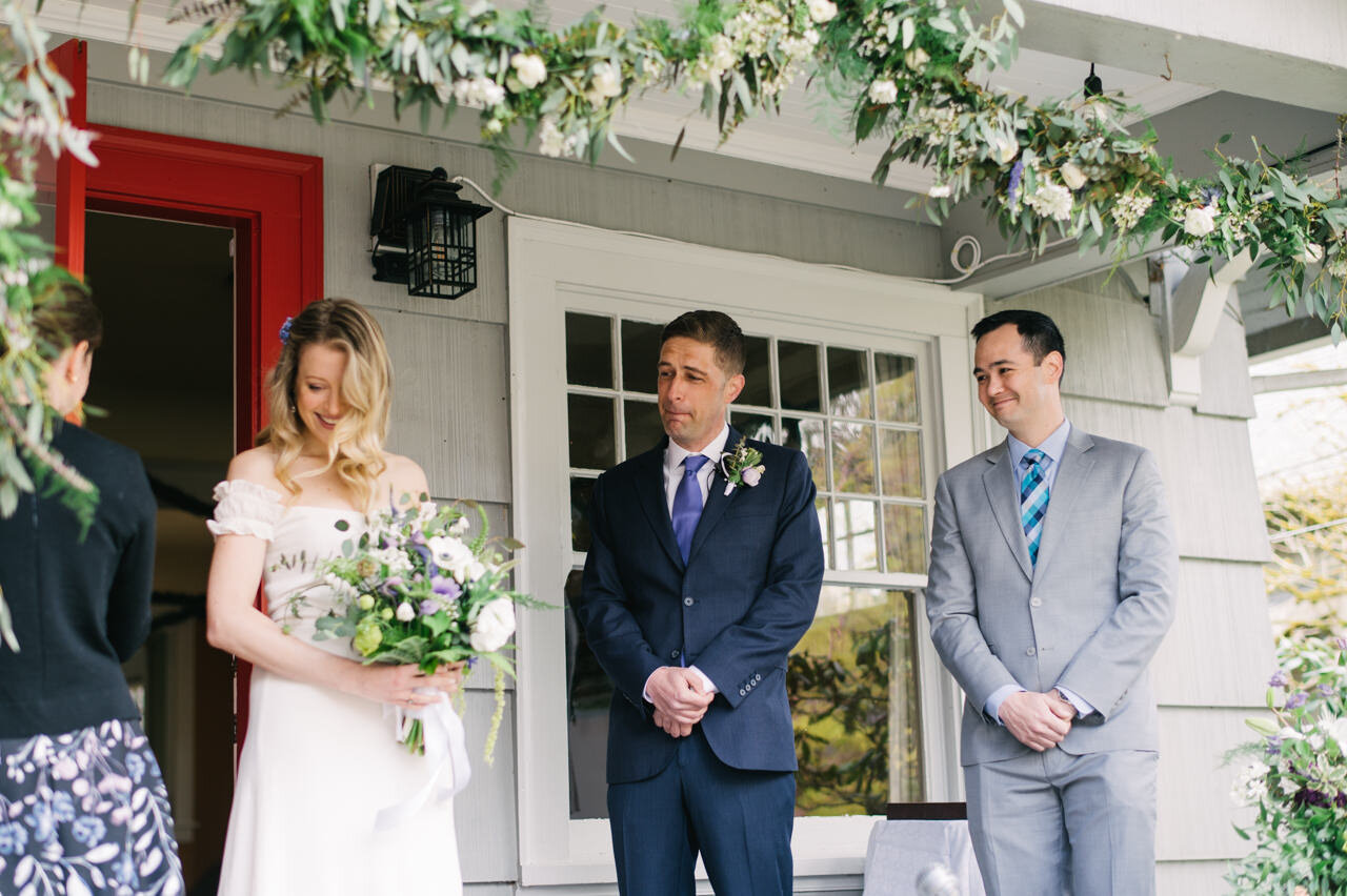  Groom chokes up while seeing bride come onto front porch for small elopement ceremony 