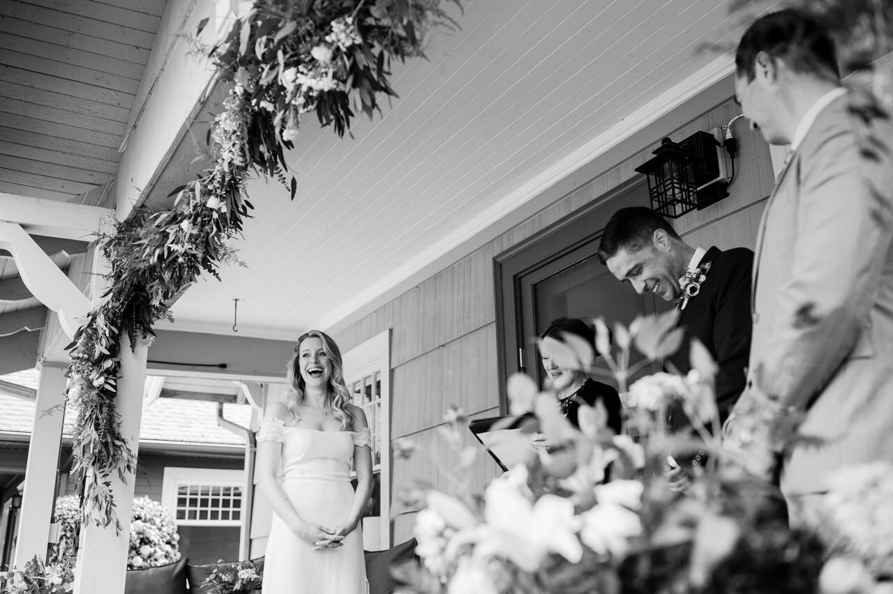  Bride laughs during elopement on front porch 